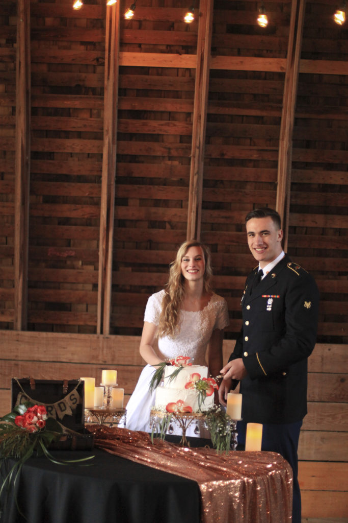 Beautiful bride and groom with a rustic backdrop